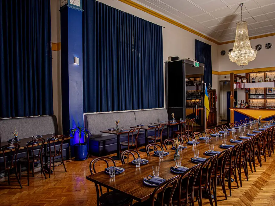Long tables set in the Kyiv Social ballroom
