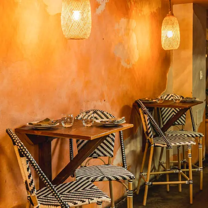 Cane chairs against the ochre wall