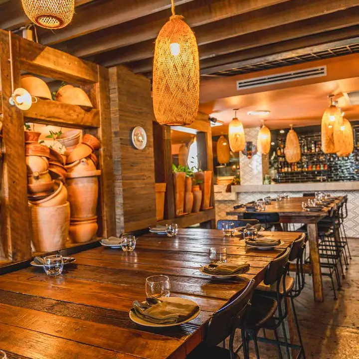 Dining room with cane lanterns and terracotta pots