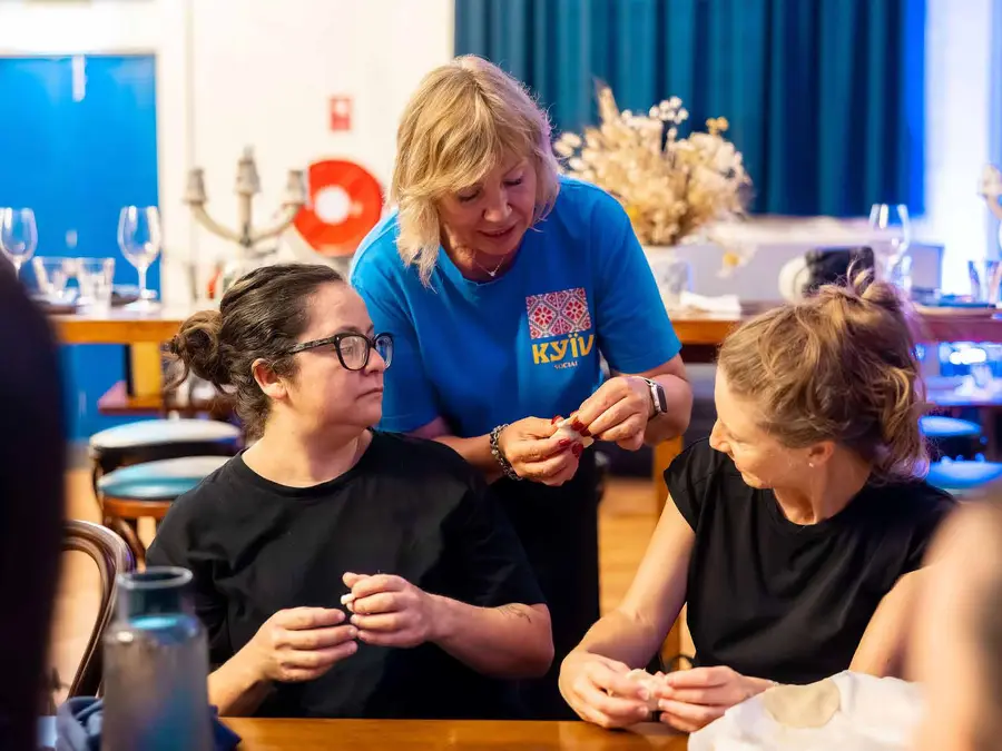 A Kyiv Social team member teaching guests to fold dumplings