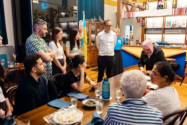Guests gathered around a table at Kyiv Social