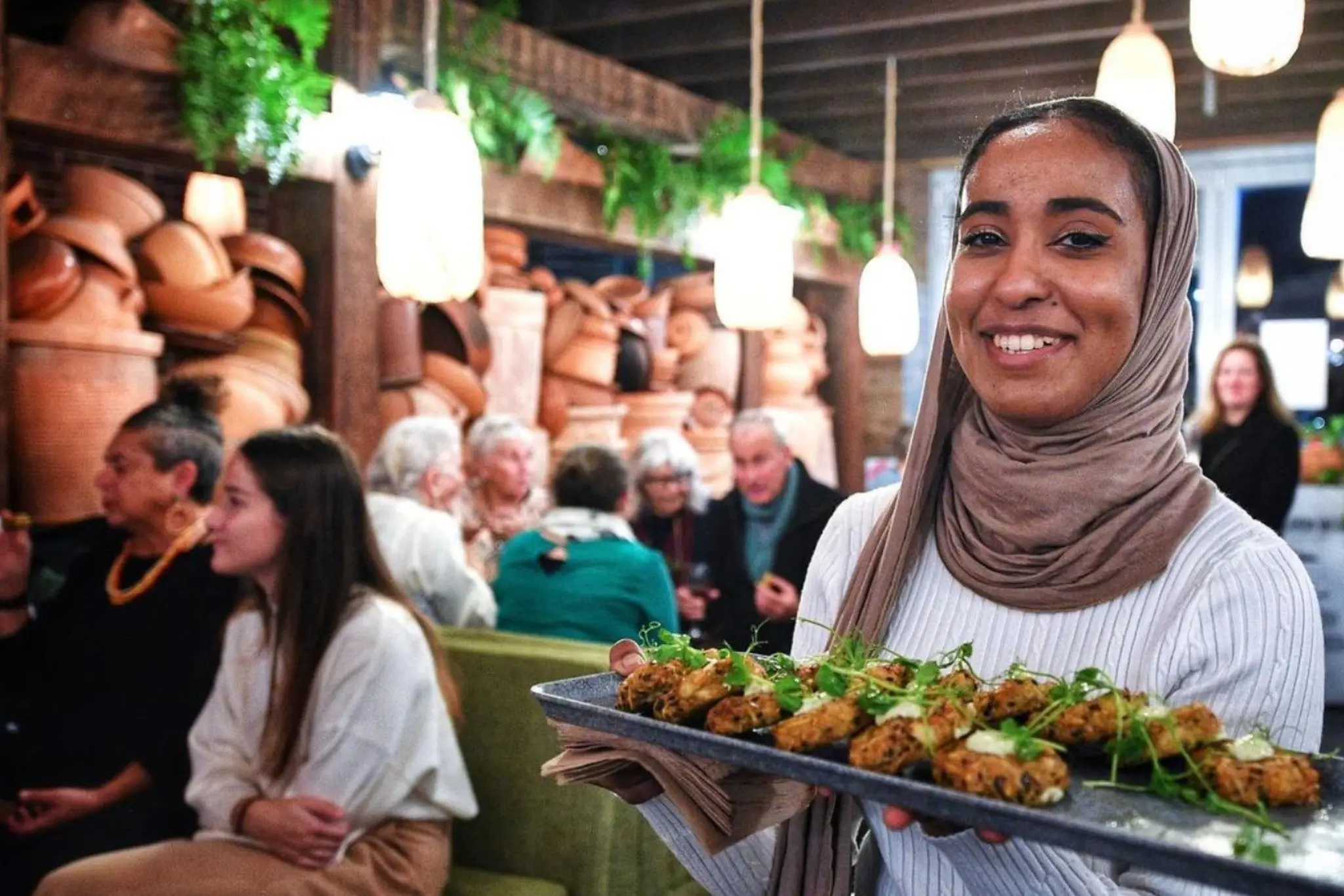Guests gathered at Colombo Social beneath cane lanterns and terracotta pots