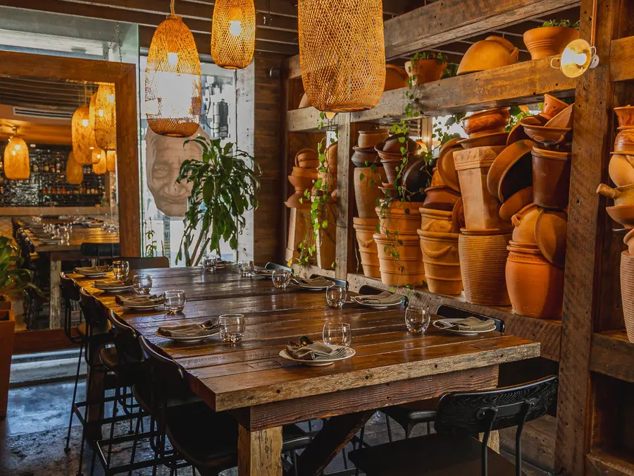 The long table at Colombo Social under cane lanterns