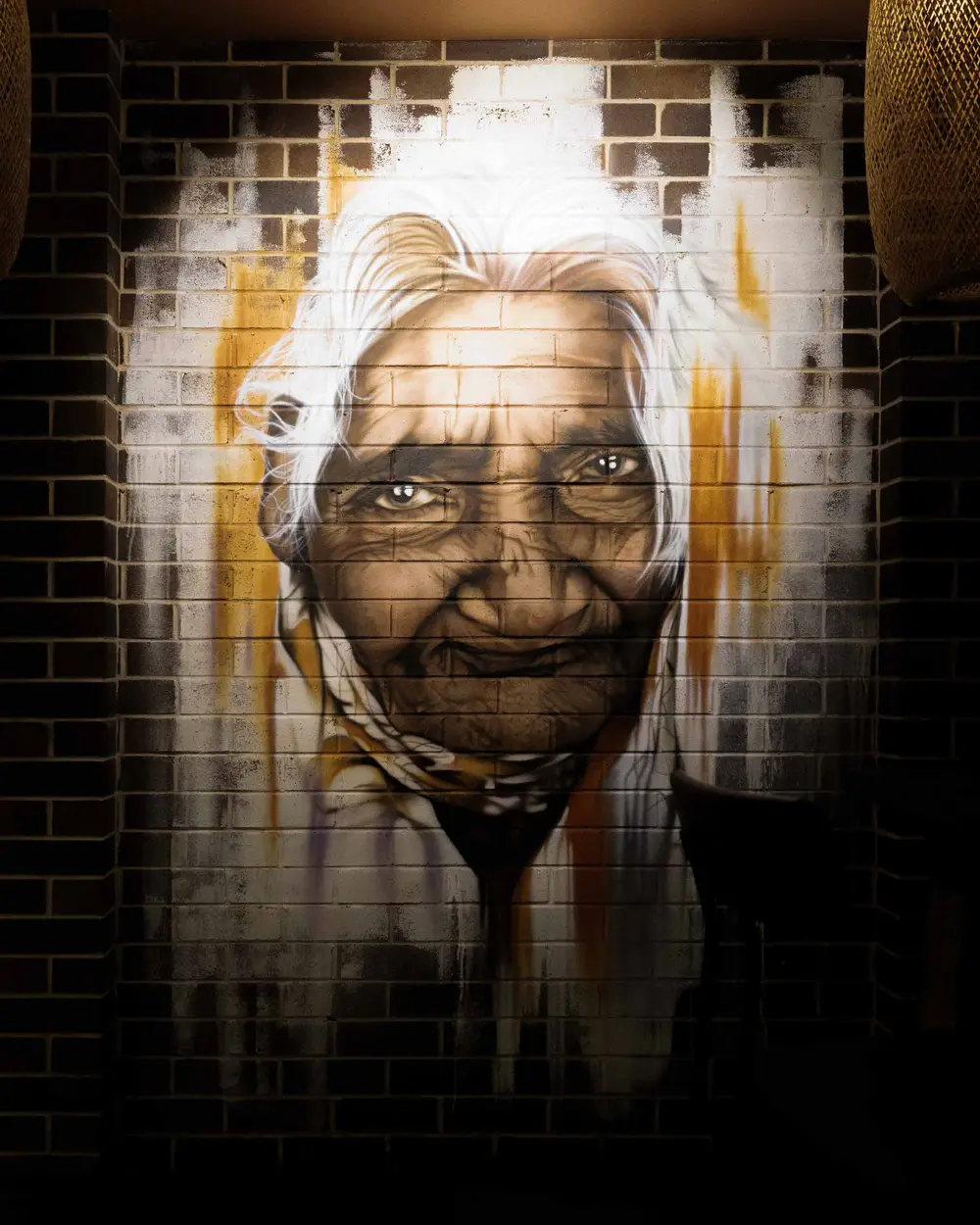 The Amma mural on the brick wall at Colombo Social