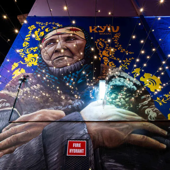 The Kyiv Social laneway mural under festoon lights