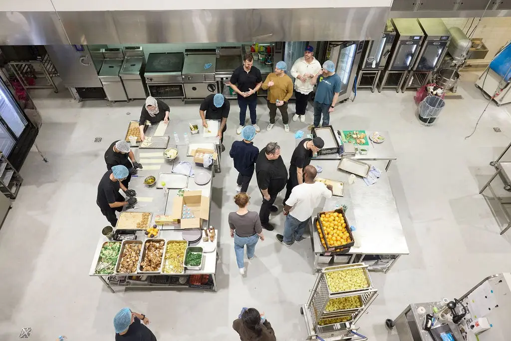 A volunteer team in the Alexandria production kitchen, seen from above
