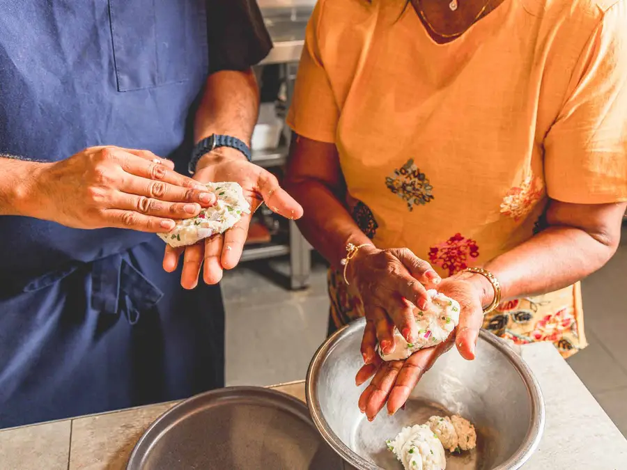 Hands shaping pan rolls at Colombo Social